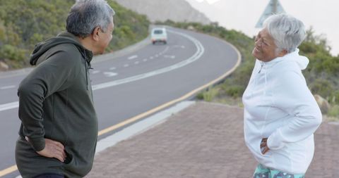 Senior Couple Resting on Scenic Mountain Road