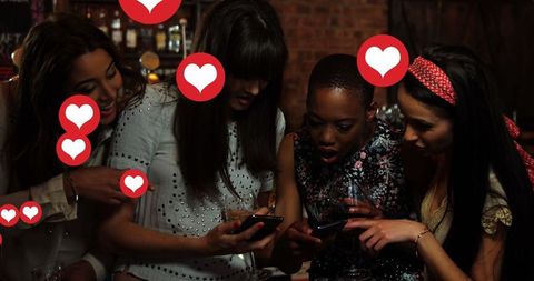 Group of Diverse Female Friends Engaging with Social Media at Night
