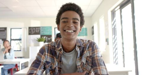 Cheerful Teen Student Smiling in Classroom Setting
