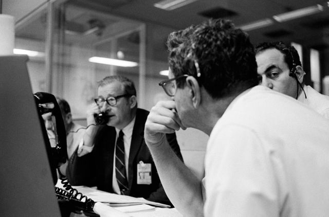 S70-34903 (14 April 1970) --- Dr. Thomas O. Paine, Administrator, National Aeronautics and Space Administration (NASA), talks on the telephone to President Richard M. Nixon.  Dr. Paine is seated at his console in the Mission Operations Control Room (MOCR) at the Mission Control Center (MCC), Manned Spacecraft Center (MSC).  Also pictured are Dr. Rocco Petrone, Apollo program director, Office Manned Spaceflight, NASA Headquarters (facing camera); and Chester M. Lee, Apollo mission director, Office of Manned Spaceflight, NASA Headquarters (HQ). Dr. Paine and the President were discussing the revised Apollo 13 flight plan following discovery of an oxygen cell failure in the Apollo 13 spacecraft several hours earlier.