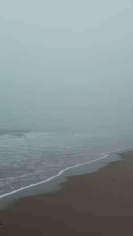 Foggy Shoreline Rolling Foam with Incoming Tide Minimalist Seascape Vertical Video