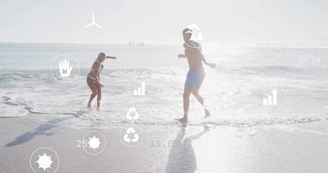 Couple Enjoying Skimboarding on Sunny Beach with Data Overlay