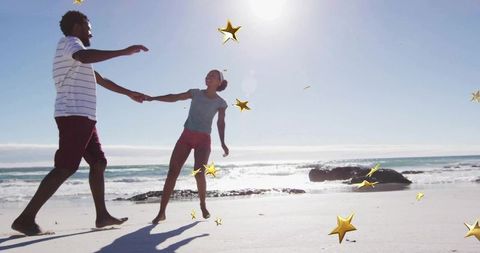 Joyful Couple Dancing on Sunlit Beach with Star Accents