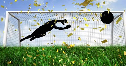 Silhouette of Goalkeeper Saving Ball with Golden Confetti