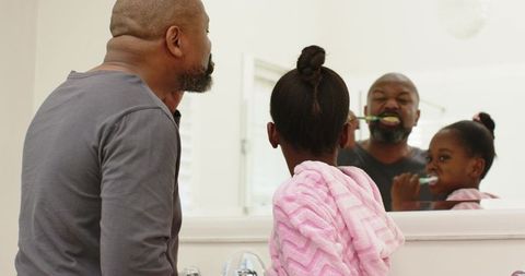 Father and Daughter Enjoy Morning Tooth Brushing Routine