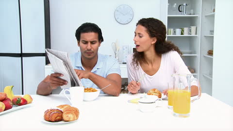 Couple Relaxing with Breakfast in Modern Kitchen