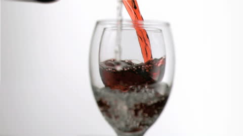 Wine and Water Pouring into Glasses in Slow Motion