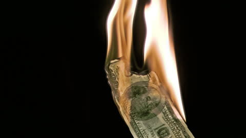 Burning Money Symbolizing Financial Loss in Slow Motion