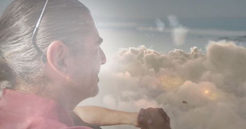 Reflective Senior Man Gazing at Luminous Clouds