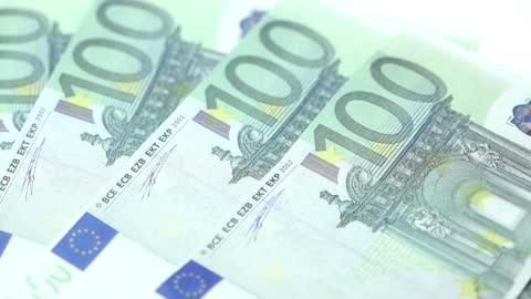 Close-up of Multiple Hundred Euro Bills on Table