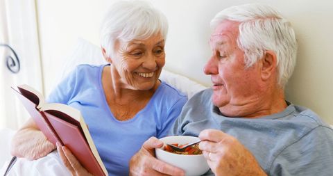 Elderly Couple Enjoying Peaceful Morning with Book and Breakfast in Bed - Download Free Stock Images Pikwizard.com