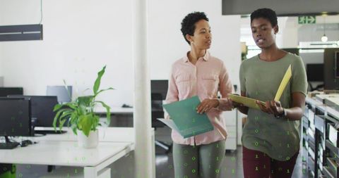 Professional Colleagues Discussing Work in Open-Plan Office