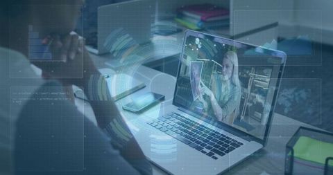 Attending remote video call on laptop with futuristic HUD overlay, workspace and notebooks