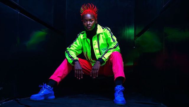 Neon fashion model in futuristic setting with cyberpunk vibes