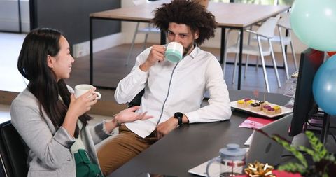 Colleagues Enjoying Coffee and Cake During Office Celebration