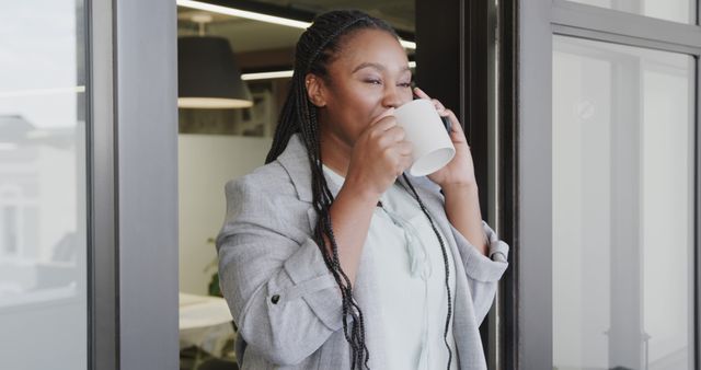 Businesswoman Enjoying Coffee Break in Modern Office - Download Free Stock Images Pikwizard.com