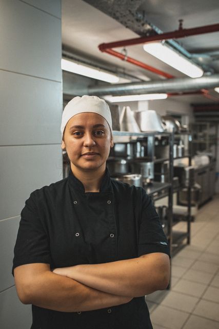 Confident Female Kitchen Manager in Restaurant Kitchen - Download Free Stock Photos Pikwizard.com