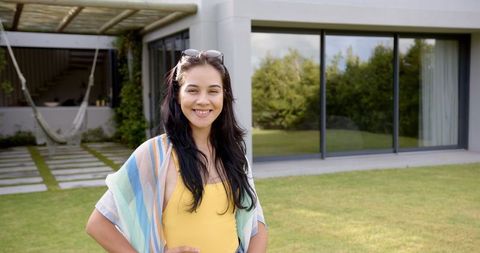Smiling Young Woman Enjoying Outdoors in Stylish Backyard Setting
