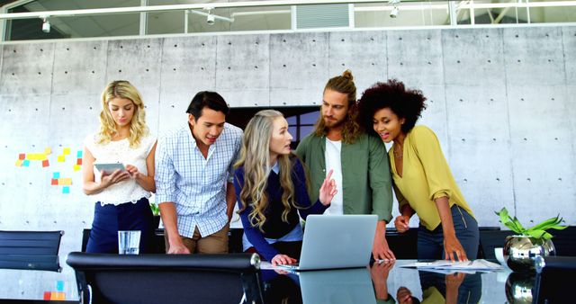 Diverse Team Collaborates Around Laptop in Modern Office - Download Free Stock Images Pikwizard.com