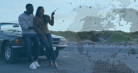 Joyful Couple Planning Road Trip with Digital World Map Overlay