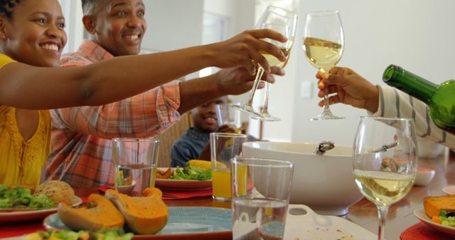 Happy Family Enjoying Thanksgiving Dinner Toasting with Wine - Download Free Stock Images Pikwizard.com