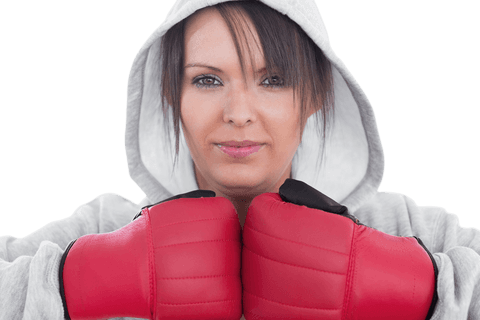 Confident female boxer in red gloves on transparent background