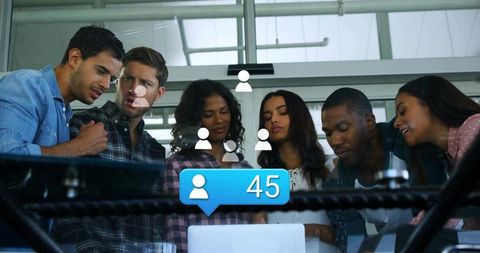 Diverse Team Exploring Social Media Strategy with Engagement Metrics Display