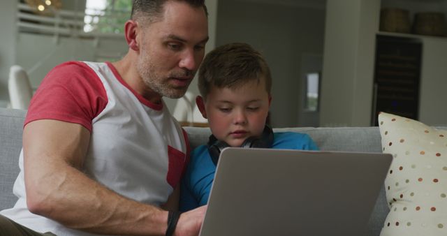 Father and Son Using Laptop Together on Couch at Home - Download Free Stock Images Pikwizard.com