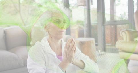 Senior woman practicing mindfulness meditation at home in serene minimalist living room