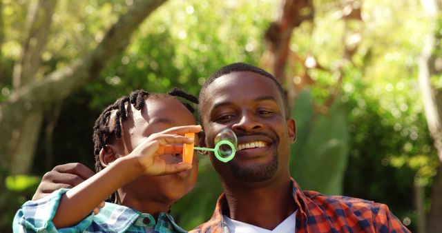 Father and Son Blowing Bubbles in Garden - Download Free Stock Images Pikwizard.com