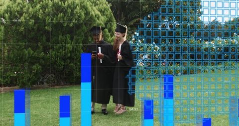 Graduates holding diplomas checking phone on campus lawn with blue data overlay