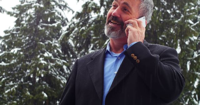 Caucasian Businessman Talking on Phone in Snowy Forest - Download Free Stock Images Pikwizard.com