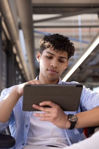 Young Professional Caucasian Man Using Tablet in Modern Office