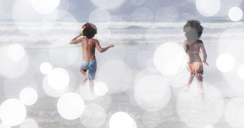 Kids running and splashing and enjoying surf with bokeh sunlit beach vibes, playful summer friends