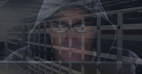 Hooded Figure Observing Data Center Infrastructure for Cybersecurity