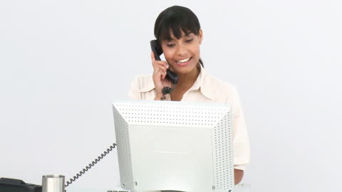 Smiling Businesswoman on Phone Call Working at Desk