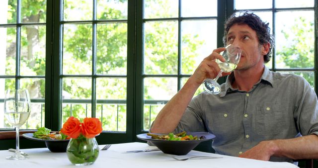 Man Enjoying a Glass of Wine in Relaxed Restaurant Setting - Download Free Stock Images Pikwizard.com