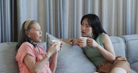 Asian Grandmother and Granddaughter Bonding Over Coffee