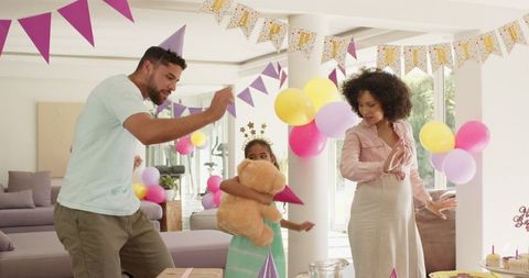 Family Celebrating Birthday Together at Home with Balloons and Gifts
