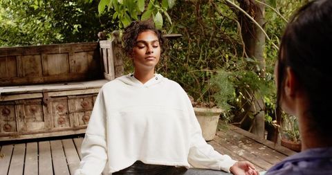 Outdoor Serenity: Women Meditating amid Lush Greenery
