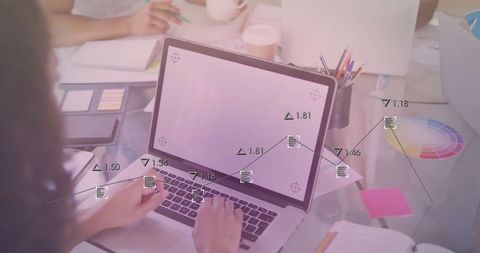 Creative Female Designer Collaborates at Office Desk with Laptop