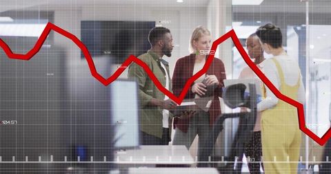 Diverse business team analyzing financial decline with line graph overlay