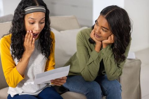 Emotional reaction to letter on sofa, family bonding moment