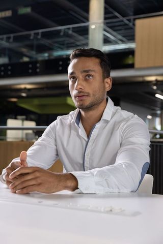 Professional in modern office engaged in work at white desk