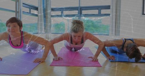 Women Practicing Push-Ups with Digital Enhancement in Studio