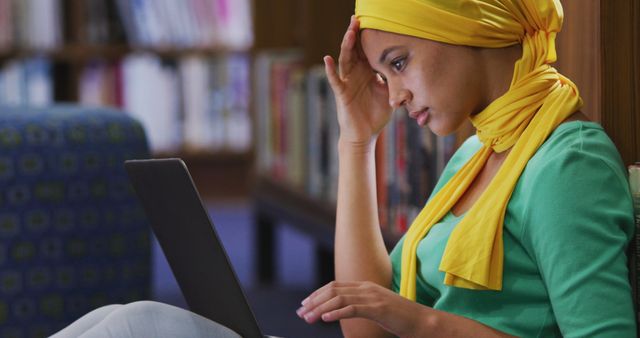 Stressed Young Woman Studying on Laptop in Library - Download Free Stock Images Pikwizard.com