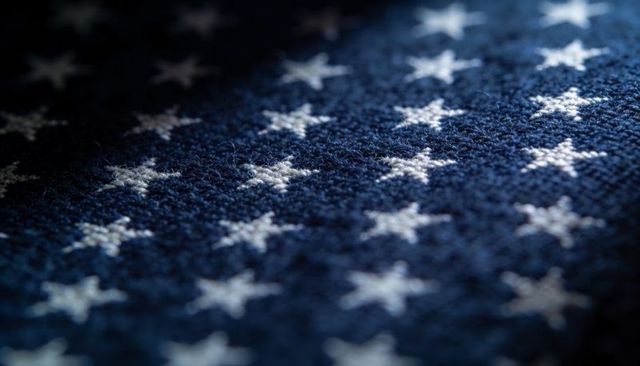 Macro knit stars on navy textile highlighting yarn texture and patriotic fabric pattern