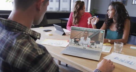 Diverse Team Engaged in Video Conference in Modern Office