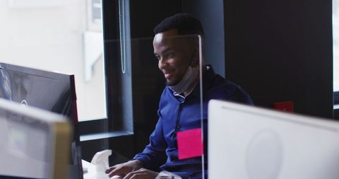 Businessman at Office Desk Using Computer with Face Mask Lowered - Download Free Stock Images Pikwizard.com