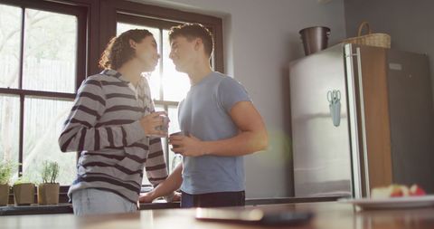 Romantic Moment Between Diverse Male Couple in Modern Kitchen